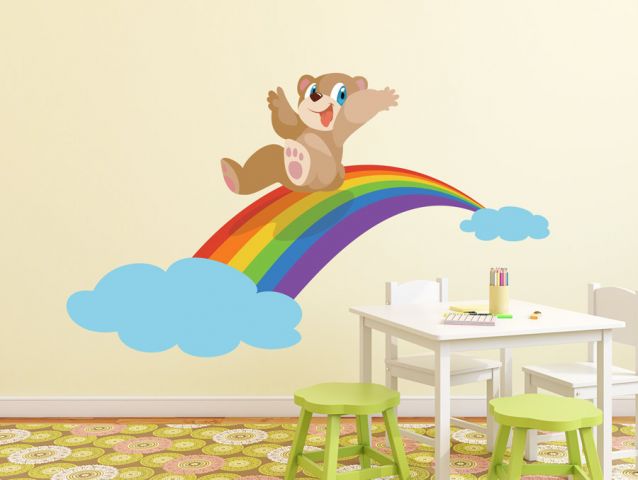 Cute teddy bear on a rainbow