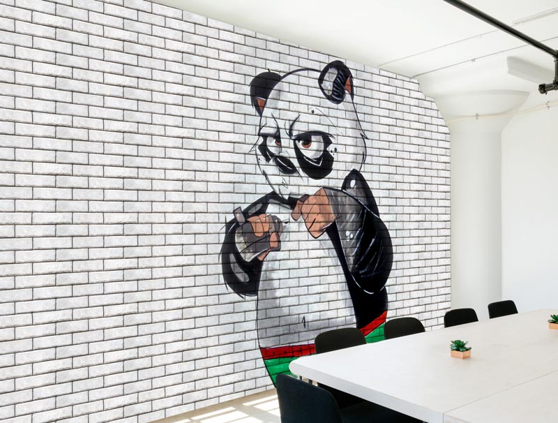 Brick wallpaper with annoyed panda graffiti