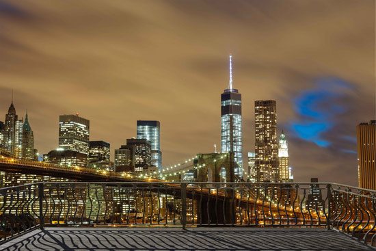 Balcony with view of a bright city at night