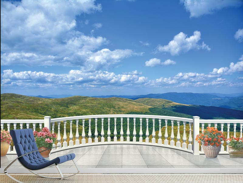 Balcony with views of green hills and blue sky